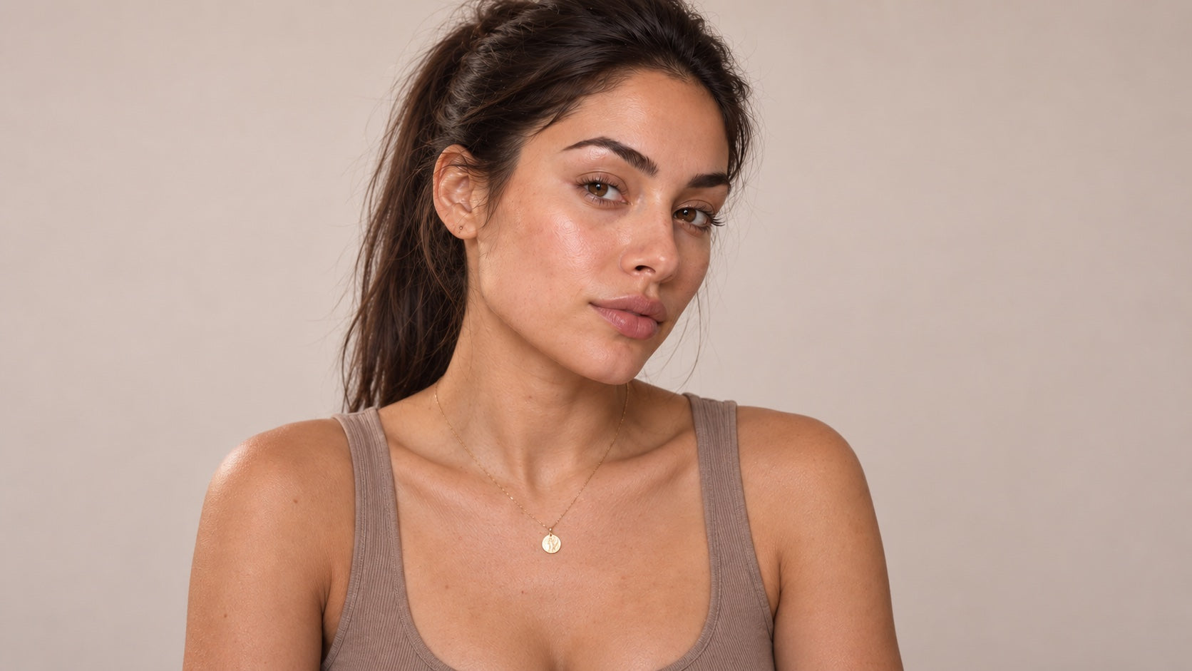 Novara's brunette model with natural skin texture in soft studio light